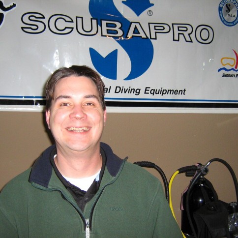 Picture of Corey Bauer in front of a Scubapro sign